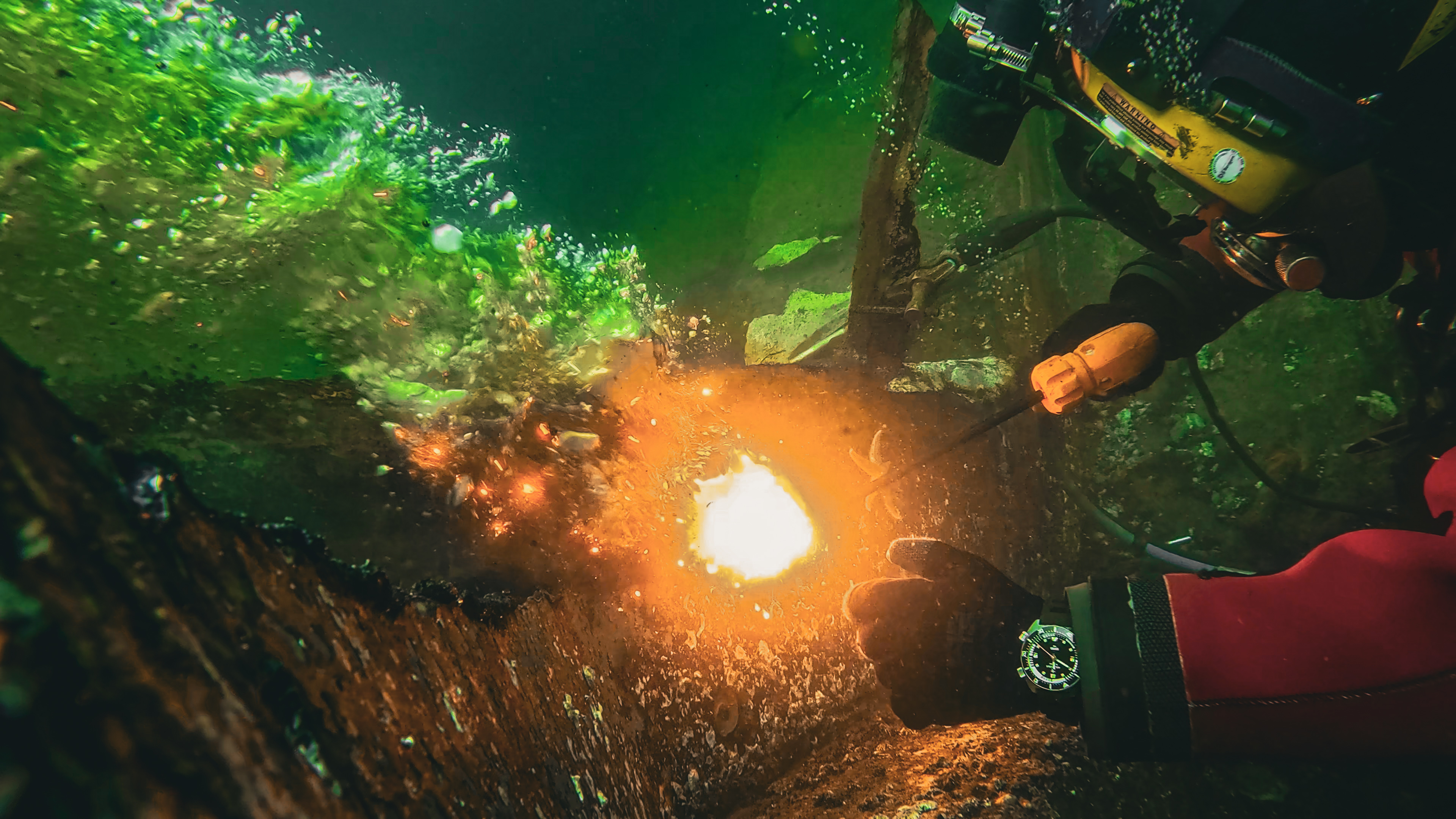 Commercial diver performing underwater welding while wearing an Aquastar Benthos