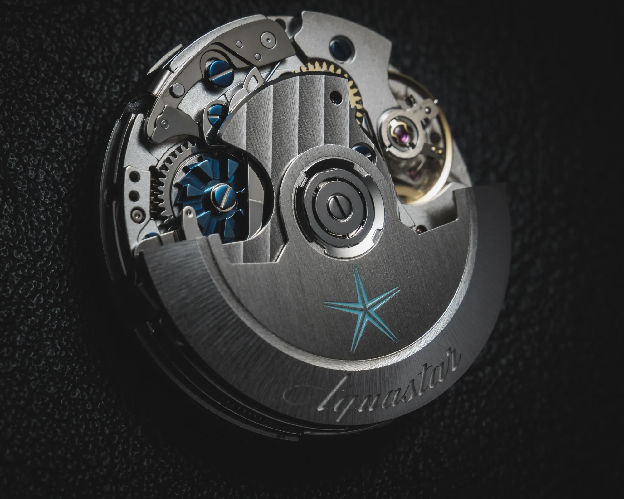 Das Aquastar Säulenrad-Chronographenwerk in Dreiviertelansicht, mit blauem Säulenrad und Aquastar-signiertem Rotor